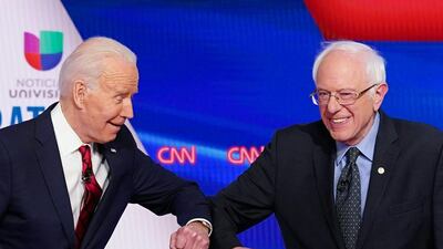Democratic presidential hopefuls Joe Biden, the former US vice president, and the Vermont senator Bernie Sanders greet each other with an elbow bump. AFP
