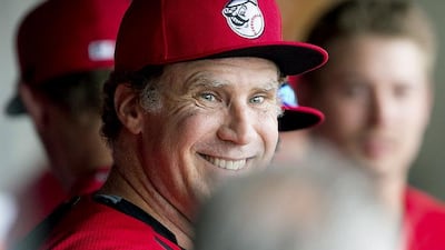 Actor Will Ferrell smiles in the dugout during a spring training baseball game between the Cincinnati Reds and the Arizona Diamondbacks on Thursday, March 12, 2015, in Scottsdale, Arizons. Ferrell made an appearance at third base for the Reds. AP