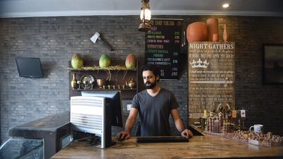 In this picture taken on August 25, 2017, owner Hammad works at his Game Of Thrones-themed restaurant named King's Landing in Islamabad. The restaurant was launched in January by four college friends who were surprised to see fans coming in with their families, despite the sometimes very violent and explicit nature of the series. / AFP PHOTO / Farooq NAEEM