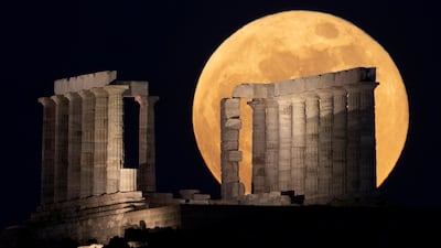 The Super Flower Blood Moon rises over the Temple of Poseidon in Cape Sounion, near Athens, Greece. Reuters