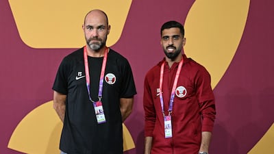 Felix Sanchez and forward Hassan Al-Haydos arrive for a press conference at the Aspire training site in Doha on November 19, 2022. AFP