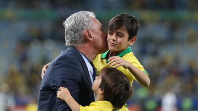 Brazil manager Tite celebrates winning the Copa America with his children. Reuters