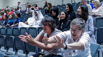 Claire Shires and Elspeth Cooper cheer for the gymnasts.