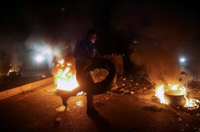 Supporters of Lebanon's former Prime Minister Saad Hariri block a road with burning tires after he said was bowing out of politics. Reuters