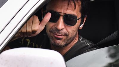 Juventus' Italian goalkeeper Gianluigi Buffon waves as he arrives in his car to attend training. AFP