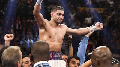 Amir Khan celebrates after his victory over Luis Collazo in their welterweight fight in Las Vegas on Saturday. Steve Marcus / Reuters / May 3, 2014