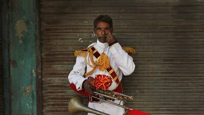 Shivshankar, 55, from Pali, a member of Master Band specializing in playing weddings, poses for a portrait in New Delhi.