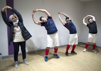 Rawdha Al Otaiba, Deputy Head of Mission at the UAE Embassy in London, takes part in stretching exercises with the Great Britain Special Olympics team. Stephen Lock for the National