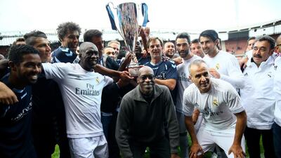 Both teams pose with the winning trophy. Christof Koepsel / Getty Images