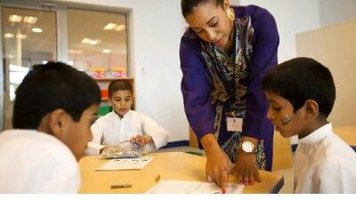 Kandance Johnson works with Sagr Samin at Mezyed School in Al Ain.