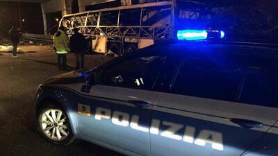 A police car is parked next to a bus that was carrying Hungarian school students home from France when it crashed on the A4 highway near Verona, Italy, on January 21, 2017. Ansa via AP