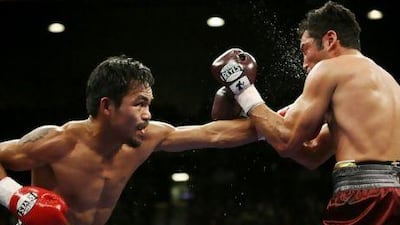 Manny Pacquiao connects on Oscar De La Hoya during their welterweight bout in 2008. Manny won with a TKO in the 8th round. STEVE MARCUS / REUTERS