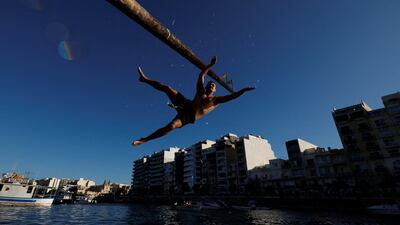 A competitor falls from the greased 'gostra' pole during St Julian’s feast in Malta. Reuters