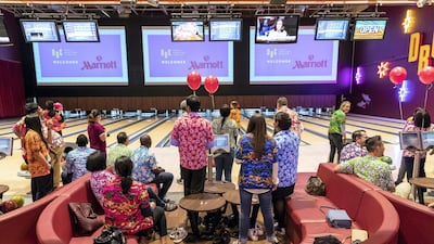 Those waiting their turn can watch movies screening on projectors above the lanes. Antonie Robertson / The National