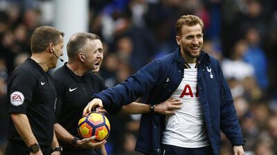 Harry Kane takes the match ball from referee Jonathan Moss after his hat-trick against Stoke City. Peter Cziborra / Reuters