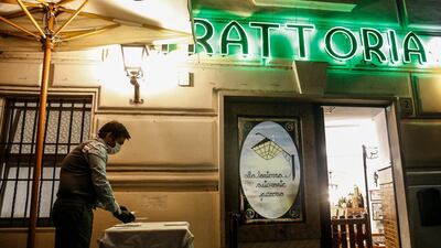 A single table outside a restaurant in Rome - Italy is gradually opening up its economy. EPA