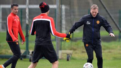 David Moyes trains with Robin van Persie on Tuesday as Manchester United prepare for Olympiakos in the Champions League on Wednesday. Paul Ellis / AFP / March 18, 2014