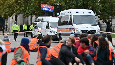 Activists block a street at Parliament Square. AFP