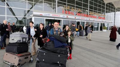 Iraqi Fuad Sharef Suleman and his family push their belongings after returning to Iraq from Egypt, where they were prevented from boarding a plane to the US, following President Donald Trump's decision to temporarily bar travellers from seven countries, including Iraq, at Erbil International Airport on January 29, 2017. Ahmed Saad/Reuters