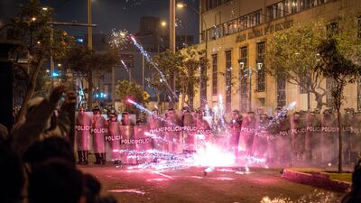 Peruvian police officers stand guard while blocking a flare near Congress during a demonstration against the new government of José Jeri in Lima, Peru. EPA