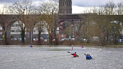 Members of a local canoe club paddle on the flooded Worcester Racecourse in England, on Sunday February 23. AP