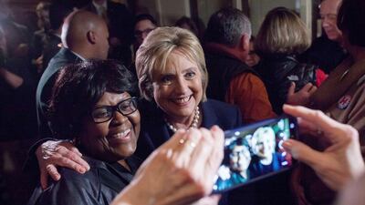 Democrat presidential candidate Hillary Clinton poses for a photo with a supporter after an election debate in Durham, New Hampshire. Matthew Cavanaugh / Getty Images / AFP