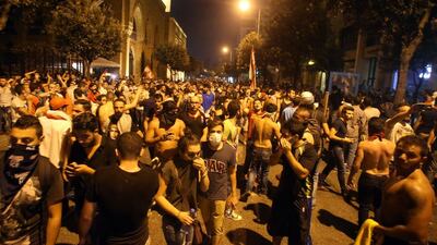 Lebanese protesters cover their faces from tear gas during clashes with security forces following a demonstration organised by the “You Stink” campaign against the ongoing trash crisis in Beirut on Saturday. At least 16 people were wounded when clashes erupted in central Beirut between Lebanese security forces and demonstrators calling for a solution to weeks of uncollected rubbish. AFP / STR