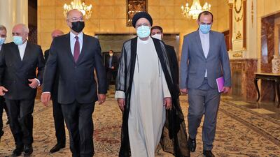 A handout picture provided by the Iranian presidency on August 5 shows President Ebrahim Raisi (centre) receiving Iraq's president Barham Saleh (centre left) in the capital Tehran. AFP