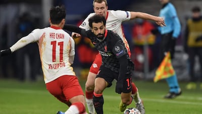 Liverpool's Egyptian midfielder Mohamed Salah (C) and Leipzig's Korean forward Hwang Hee-chan (L) vie for the ball. AFP
