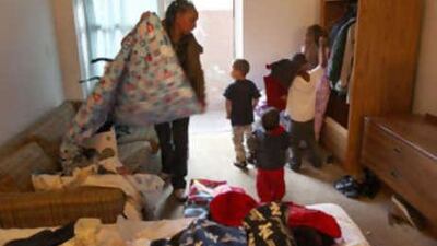 Danielle Brock speaks to her child, Lamar, at a motel in Denver, where she has been living since she was laid off from her job. l