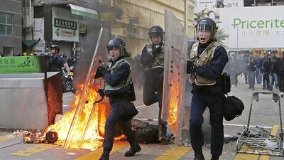 Riot police move towards protesters on a street in the Mongkok district of Hong Kong on February 9, 2016. Kin Cheung/AP Photo