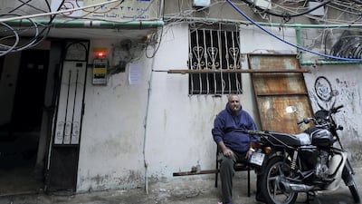 A Palestinian refugee sits at the entrance of the United Nations Relief and Works Agency for Palestine in the Burj Al Barajneh camp. JOSEPH EID / AFP
