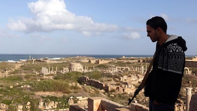A Libyan man stands guard in the ancient Roman city of Leptis Magna in Al Khums. Mahmud Turkia/AFP