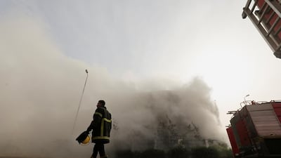 A firefighter is seen at the scene after a fire broke out in a garment factory north of Cairo, Egypt. Reuters