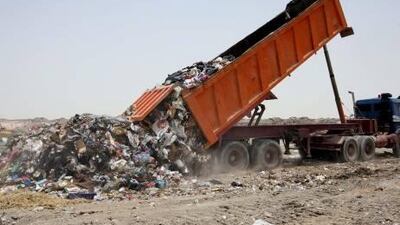 A lorry tipping domestic waste at the Maqatra land fill site between Abu Dhabi and Hmeem.