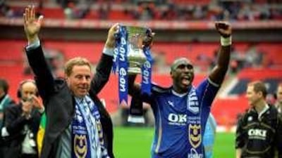 The former Portsmouth manager Harry Redknapp and the captain Sol Campbell lift the FA Cup last season.