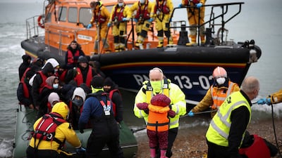 Migrants are brought ashore by RNLI Lifeboat staff, after having crossed the channel, in Dungeness, Britain. Reuters