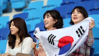 Some South Korea fans arrive early before the start of their Asian Cup match.