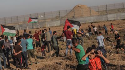 Palestinian protesters attend weekly Friday protests near the border between Israel and Gaza Strip. EPA