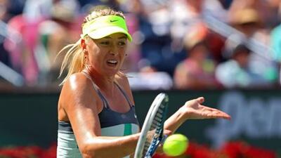Marai Sharapova returns a shot to Caroline Wozniacki during the women's BNP Paribas Open final.