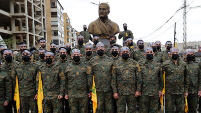 Hezbollah members stand at attention during during a ceremony in Beirut, Lebanon. AP