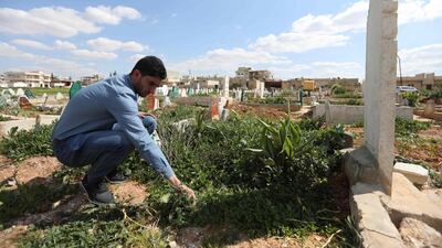 Abdulhamid Yusuf, who lost 19 members of his family, including his wife and two children, visits the graves of his relatives in Khan Sheikoun, on March 31, 2018. Omar Haj Kadour / AFP Photo