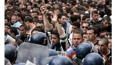 Students face policemen during a march in central Algiers in defiance of a government ban on demonstrations in the Algerian capital.