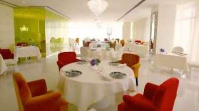 Rhodes Mezzanine's distinctive white dining room features occasional bursts of colour.