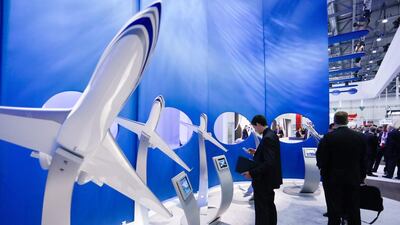 A visitor looks at replica aircrafts at the Gulfstream booth. Pierre Albouy / Reuters