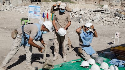 Members of a demining squad take part in an operation to clear mines in the Old City of Mosul.