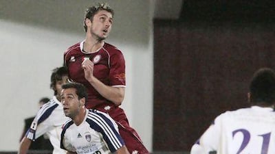 Abu Dhabi, United Arab Emirates - January 17, 2013. Alex Brosque ( no 32 of Al Ain in white ) and Dino Djulbic ( no 6 of Al Wahda in maroon ) in action, during their Etisalat Cup tournamnet. ( Jeffrey E Biteng / The National )