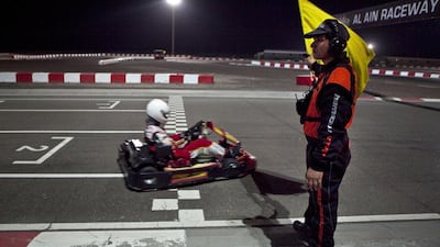 A race marshal waves off go kart drivers as they take off for the practice round while competing in the Ramadan Super Prix Challenge at the Al Ain Raceway Track in Al Ain. Abdullah Suleiman Al Rawahi (11) won the tournament, followed by his brother Sanad Suleiman al Rawahi. Silvia Razgova / The National