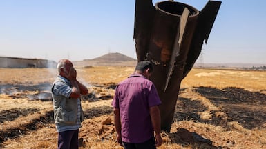 Syrian farmerer react next to an Iranian missile that fell into an agricultural land in the area of Najha, in the countryside of the Syrian capital after being intercepted by Israeli air defense systems on June 8, 2026. Iraq and Syria closed their airspace as a safety precaution on June 7 after their eastern neighbour Iran launched missiles across their territory towards targets in Israel. In a brief statement, the Iraqi Civil Aviation Authority reported the closure of Iraqi airspace for 72 hours. Syria's authority closed the country's "southern air corridors" for 12 hours. (Photo by Bakr ALKASEM / AFP)