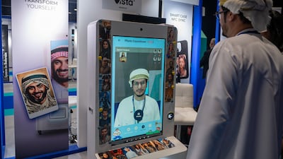 Visitors at an AI photobooth during Abu Dhabi's Global Media Congress in November. The emirate's comprehensive embrace of artificial intelligence will touch the lives of everyone who lives in it. Ryan Lim for The National